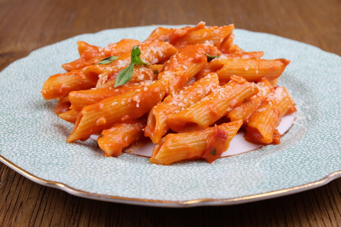 Penne pasta with tomato sauce on a decorative plate